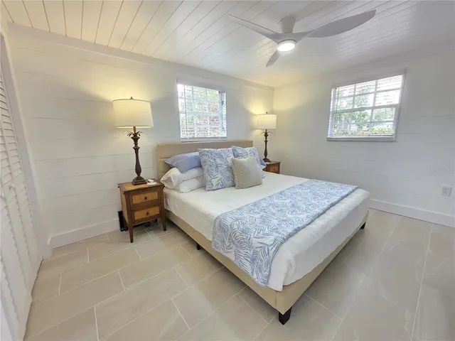 a bedroom with a bed and a table