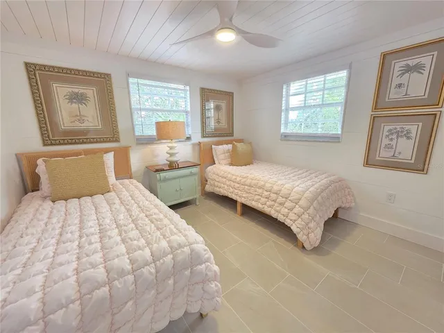 a bedroom with two beds and a window