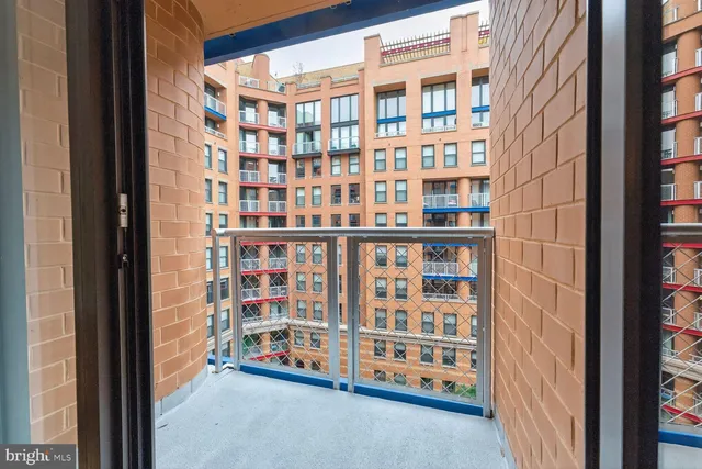 a view of front door with brick walls
