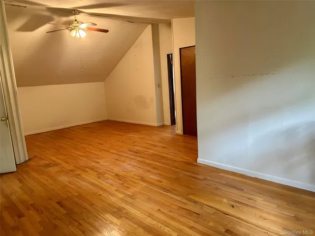 a view of a swimming pool with a slide and a tree