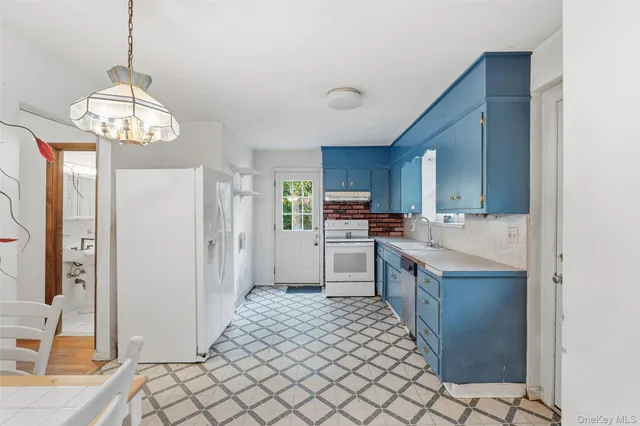a bathroom with a sink a toilet and a window