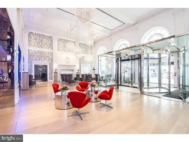 a living room with furniture a fireplace and flat screen tv