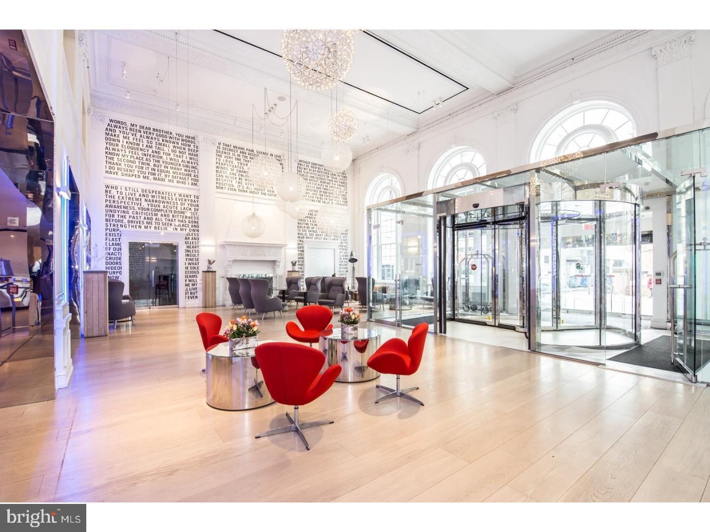 1701 Locust Street, Unit 1517 Philadelphia, PA 19103 - Photo 2 of 16 a living room with furniture a fireplace and flat screen tv