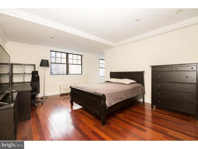 a bedroom with a bed and with furniture