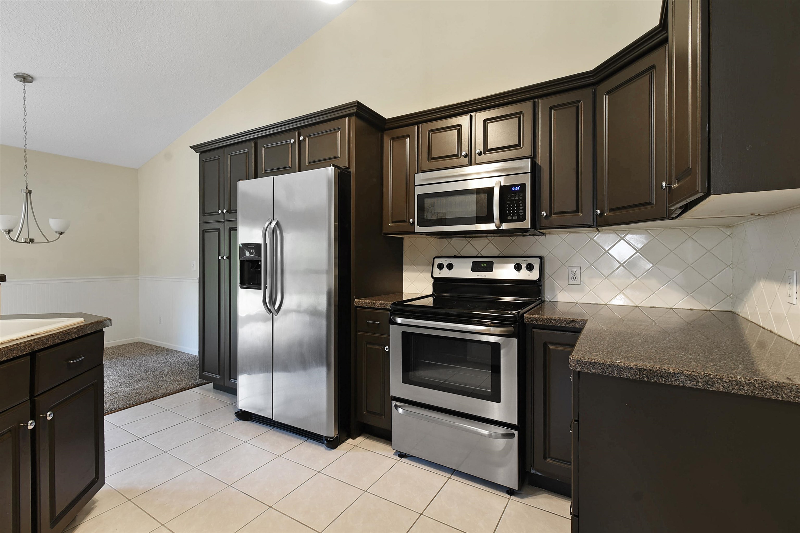 131 Osprey Road St. Augustine, FL 32086 - Photo 15 of 50 a kitchen with granite countertop stainless steel appliances and a sink
