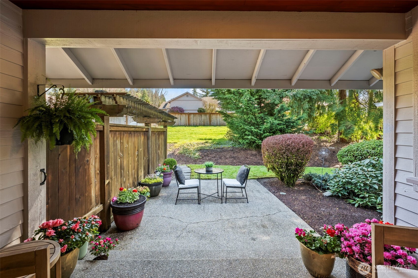 5203 53rd Street West University Place, WA 98467 - Photo 22 of 24 a view of a patio with table and chairs potted plants