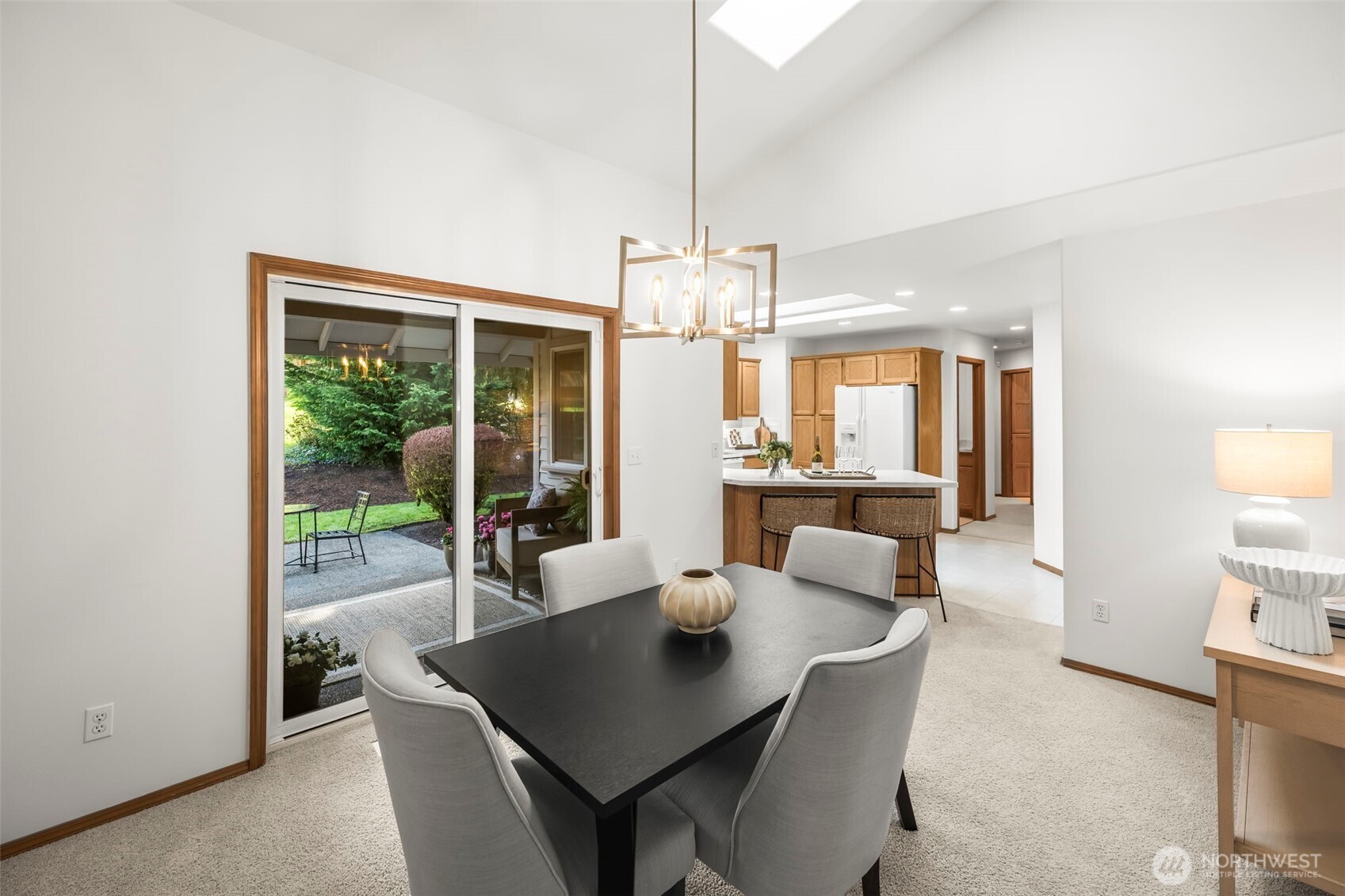 5203 53rd Street West University Place, WA 98467 - Photo 8 of 24 a view of a dining room with furniture large windows and a chandelier