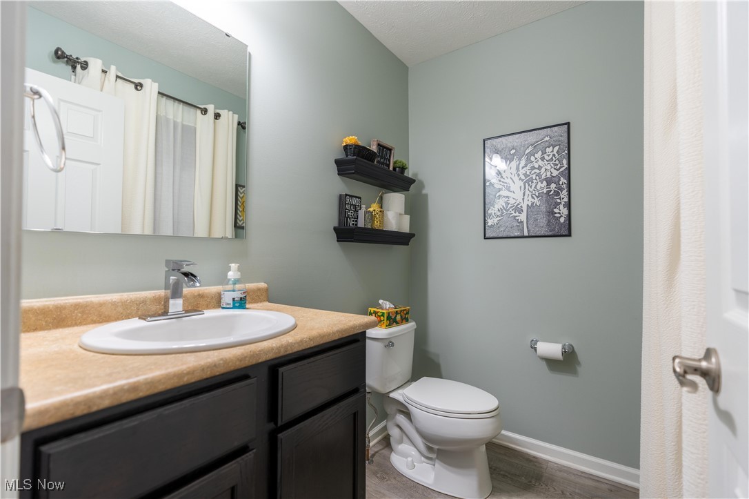 2542 Call Road Stow, OH 44224 - Photo 21 of 47 Bathroom featuring toilet, vanity, and hardwood / wood-style floors