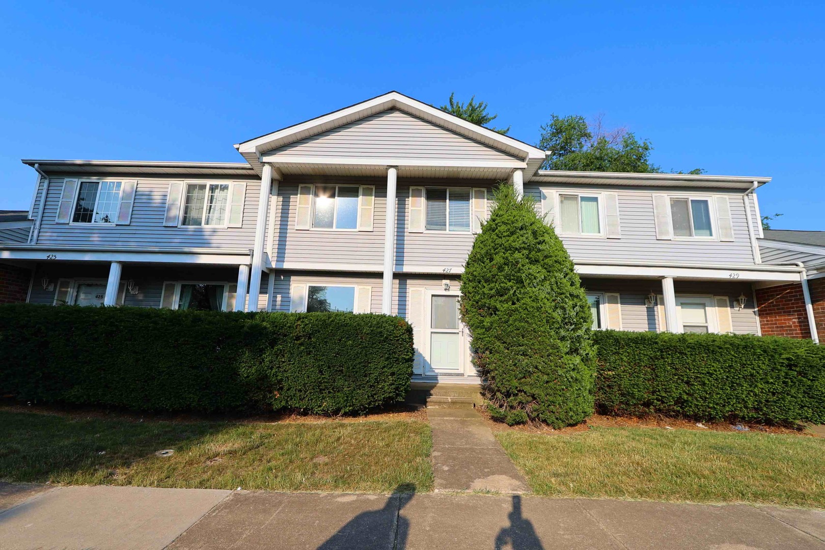 427 Mallview Lane, Unit 427 Bolingbrook, IL 60440 - Photo 1 of 16 a front view of a house with a garden