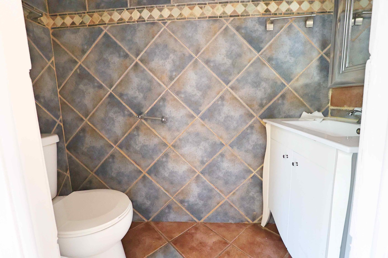 427 Mallview Lane, Unit 427 Bolingbrook, IL 60440 - Photo 12 of 16 a white toilet sitting next to a white sink and a shower curtain