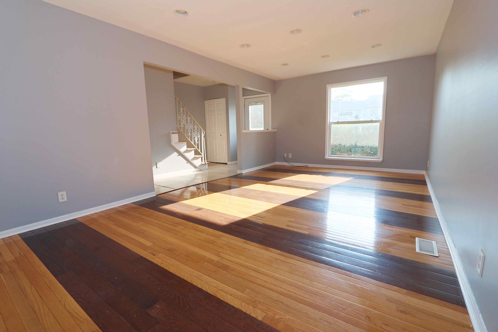 427 Mallview Lane, Unit 427 Bolingbrook, IL 60440 - Photo 3 of 16 an empty room with wooden floor and windows