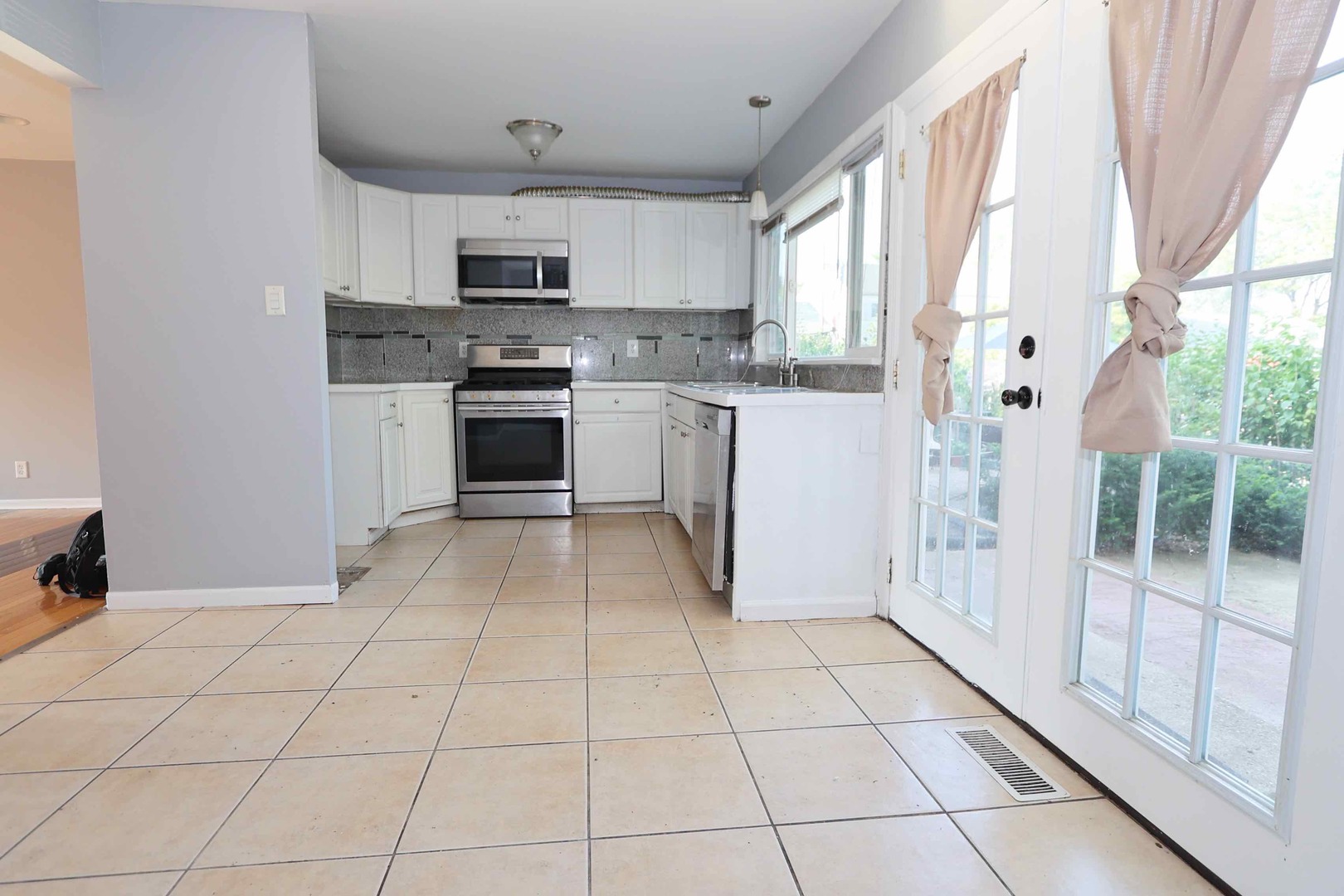427 Mallview Lane, Unit 427 Bolingbrook, IL 60440 - Photo 4 of 16 a kitchen with granite countertop a stove a sink and a microwave