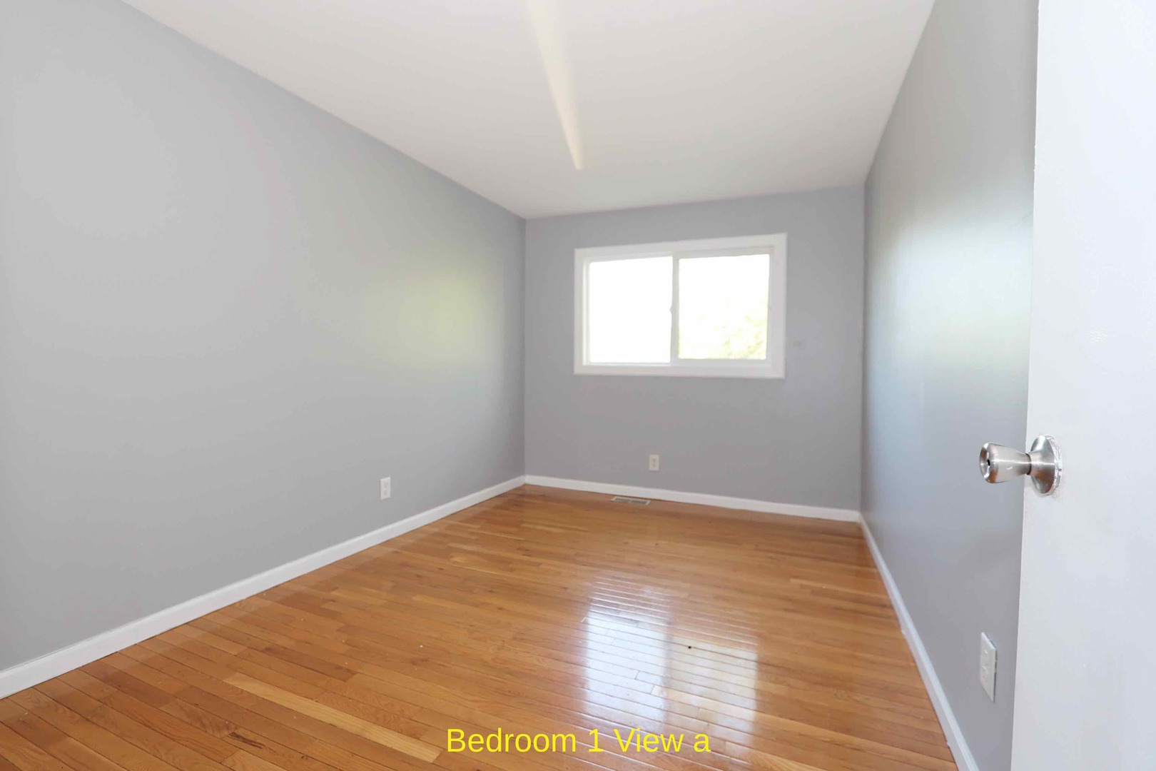 427 Mallview Lane, Unit 427 Bolingbrook, IL 60440 - Photo 6 of 16 an empty room with wooden floor and windows