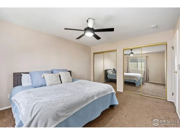 a bedroom with a bed and ceiling fan