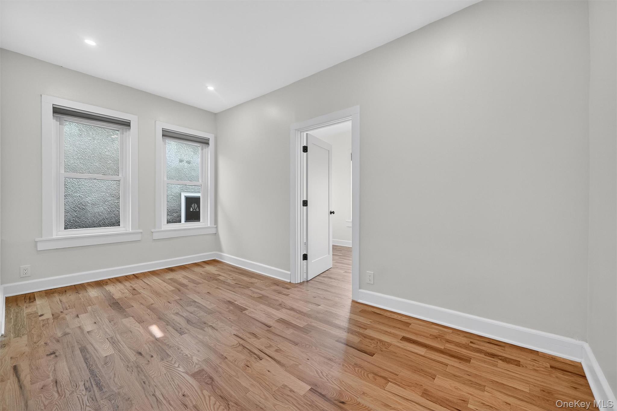 79 Main Street, Unit 2E Ossining, NY 10562 - Photo 12 of 20 a view of an empty room with wooden floor and a window
