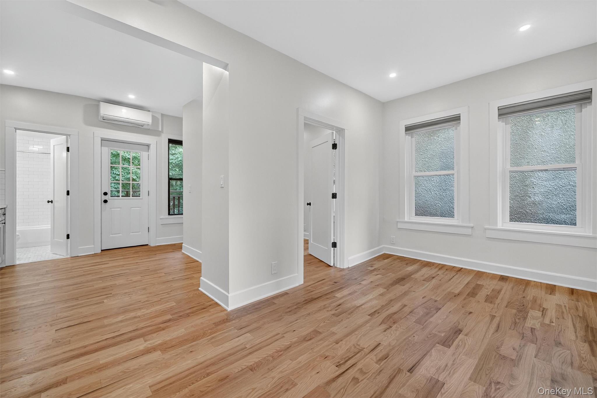 79 Main Street, Unit 2E Ossining, NY 10562 - Photo 8 of 20 a view of an empty room with wooden floor and windows
