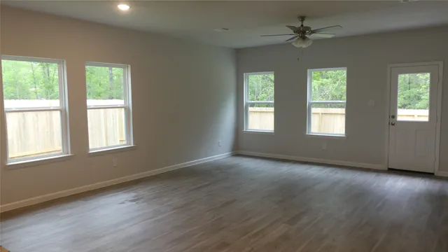 a kitchen with granite countertop a sink stove and refrigerator