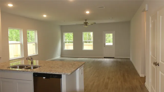 a kitchen with granite countertop a refrigerator and a sink