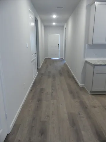 a kitchen with granite countertop a refrigerator and a sink