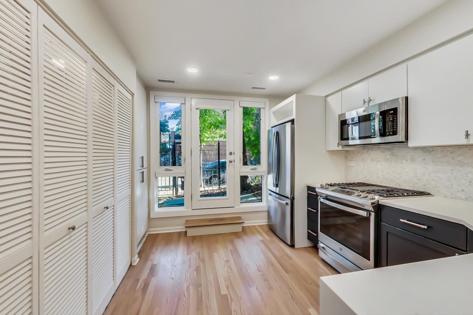 20 West 15th Street, Unit B Chicago, IL 60605 - Photo 2 of 21 a kitchen view with wooden floor and stainless steel appliances