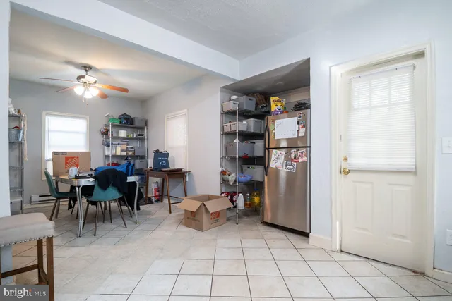 a view of a workspace with furniture and a kitchen