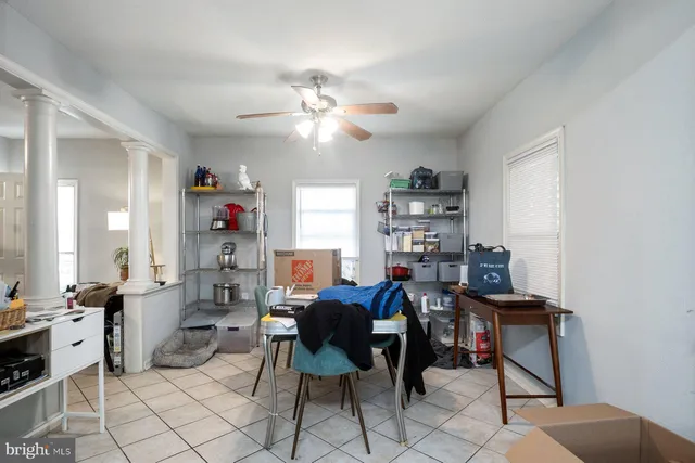 a view of a workspace with furniture and a window