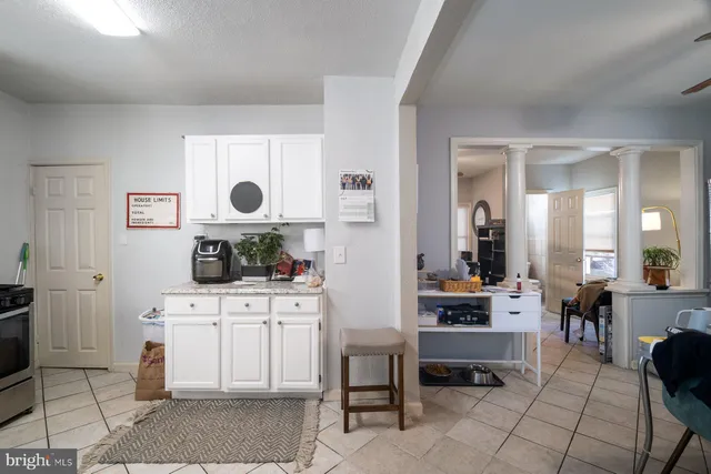 a living room with furniture a dining table and chairs