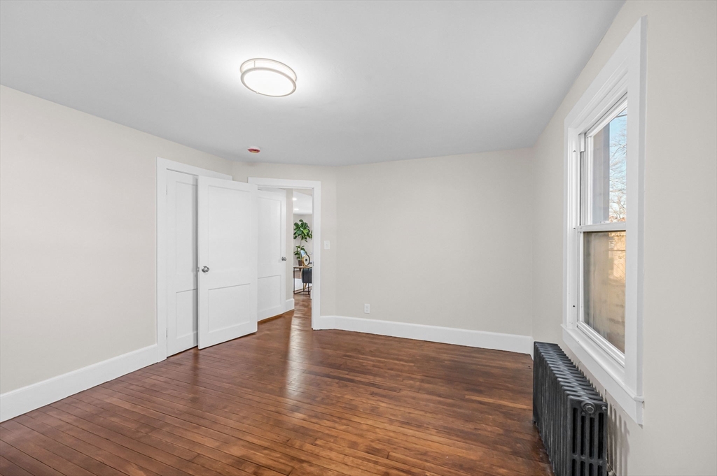 97 Parallel Street Springfield, MA 01104 - Photo 15 of 42 a view of an empty room with wooden floor and a window