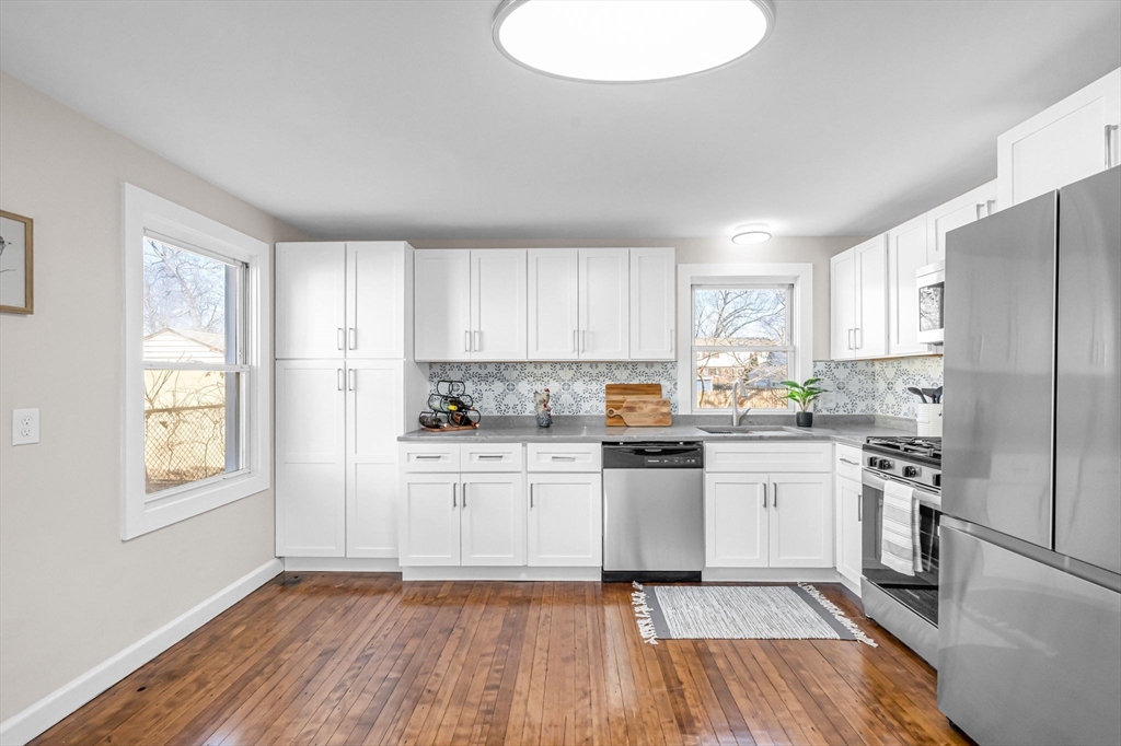97 Parallel Street Springfield, MA 01104 - Photo 10 of 42 a kitchen with white cabinets appliances and window