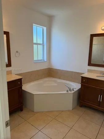 a bath tub sitting in a bathroom next to a window