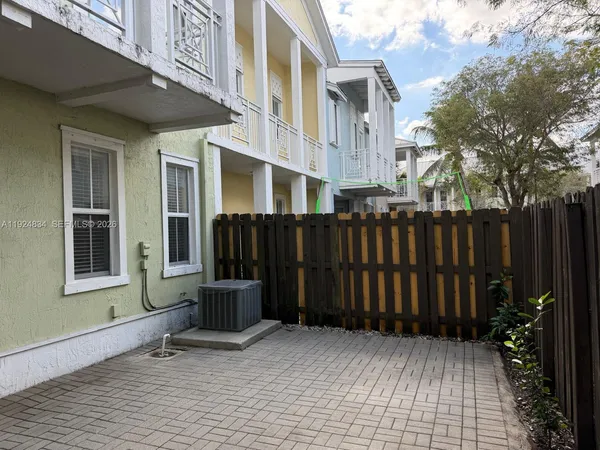 a view of a house with wooden fence