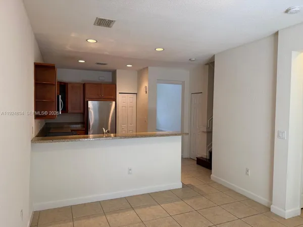 a view of a refrigerator in kitchen and wooden floor