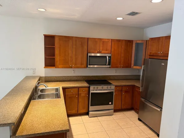 a kitchen with a sink a stove and cabinets