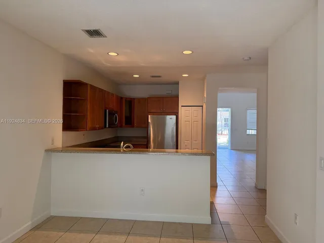 a view of a kitchen with a sink and cabinets