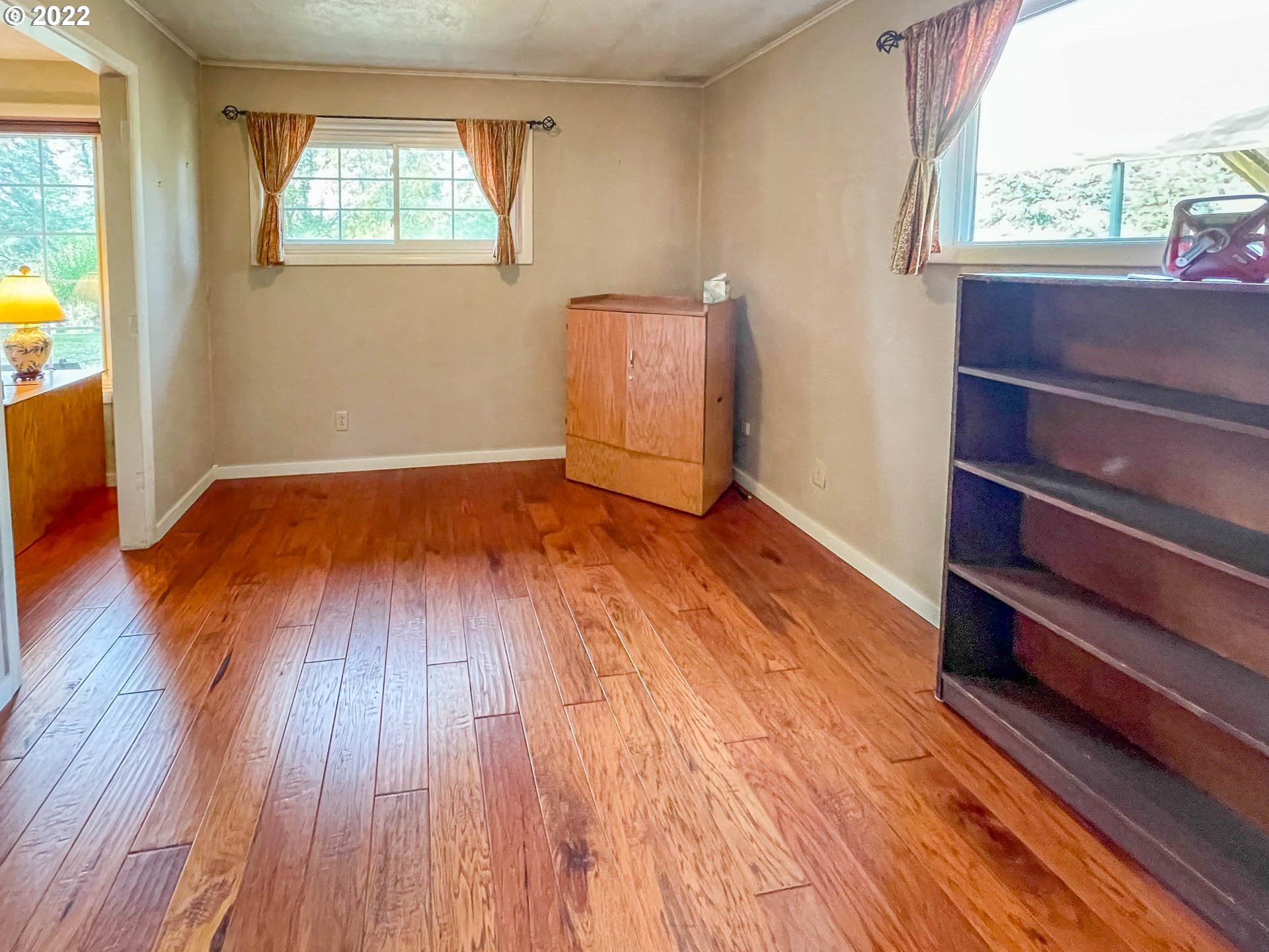 695 Lone Rock Road Glide, OR 97443 - Photo 11 of 48 wooden floor in an empty room with a window