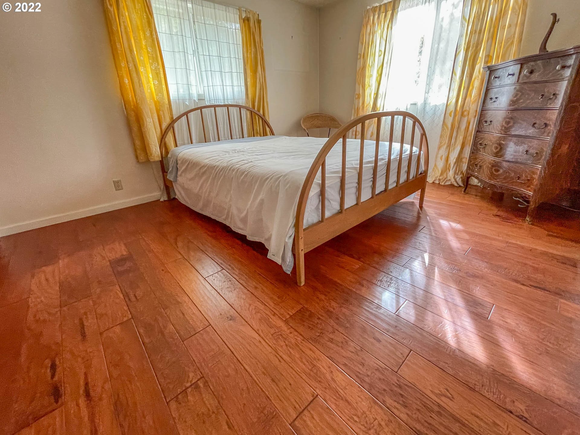 695 Lone Rock Road Glide, OR 97443 - Photo 13 of 48 a bed sitting in a spacious bedroom next to a window