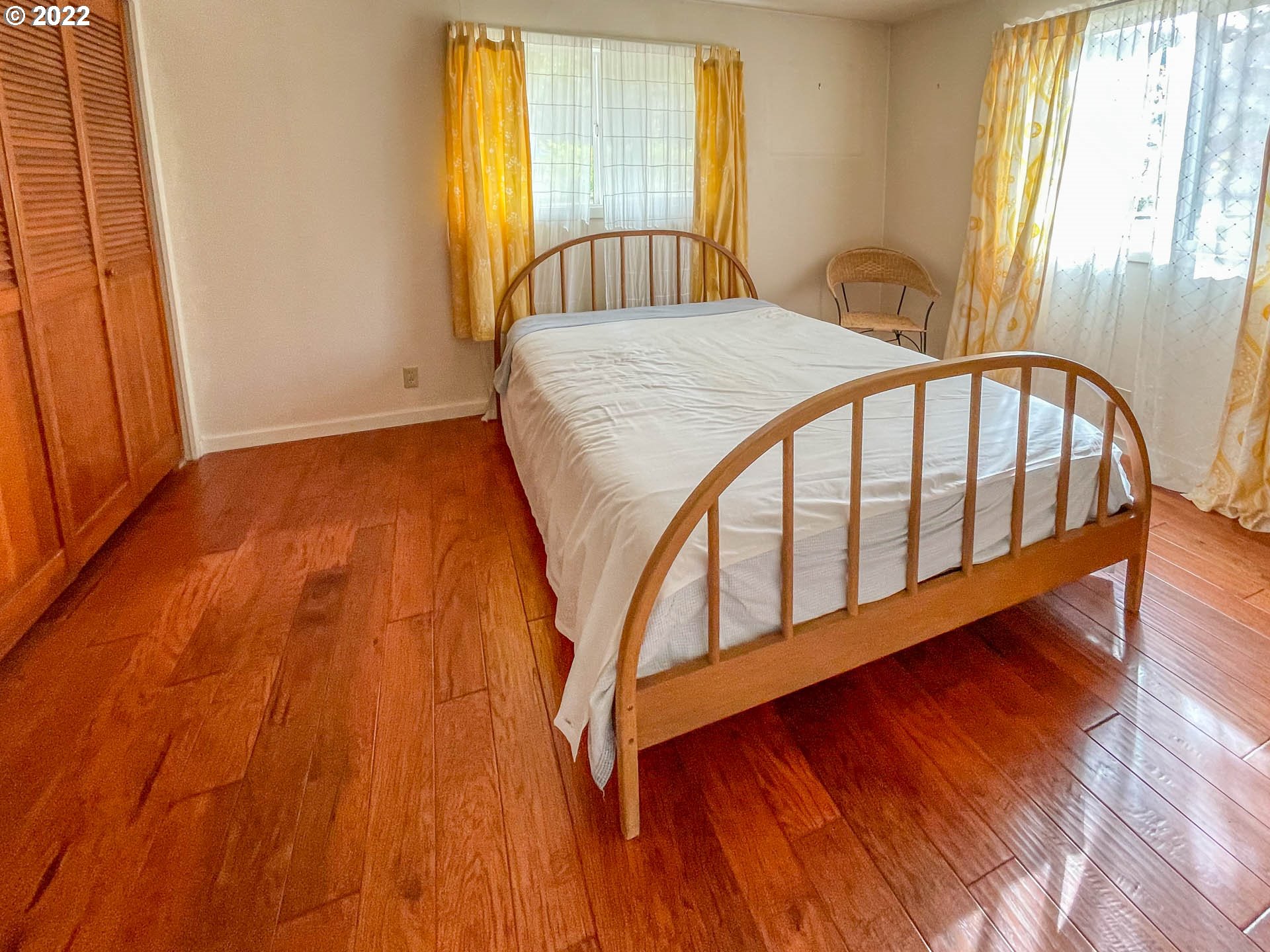 695 Lone Rock Road Glide, OR 97443 - Photo 14 of 48 a bedroom with a bed and wooden floor
