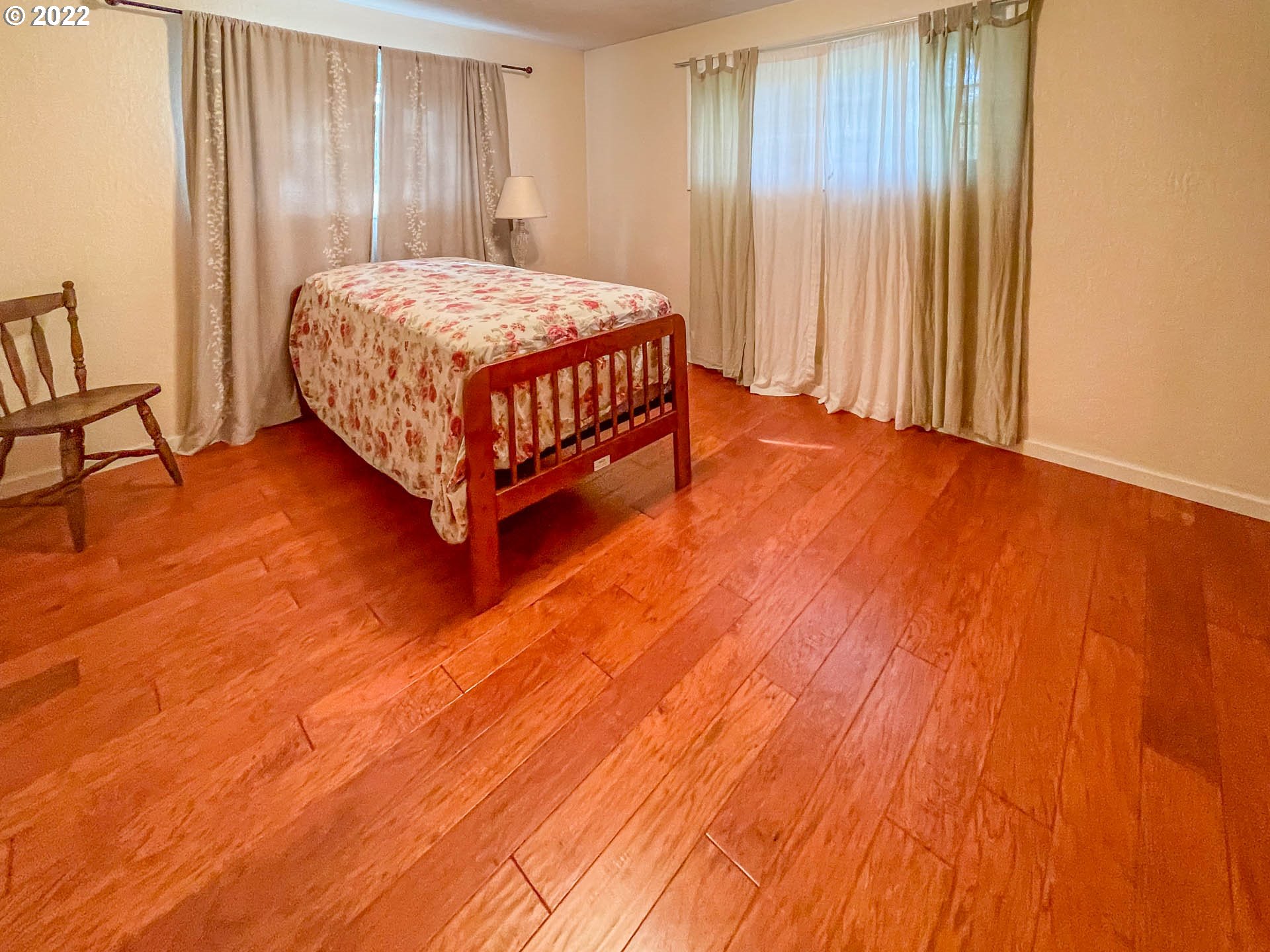 695 Lone Rock Road Glide, OR 97443 - Photo 16 of 48 a bedroom with a bed rug and wooden floor