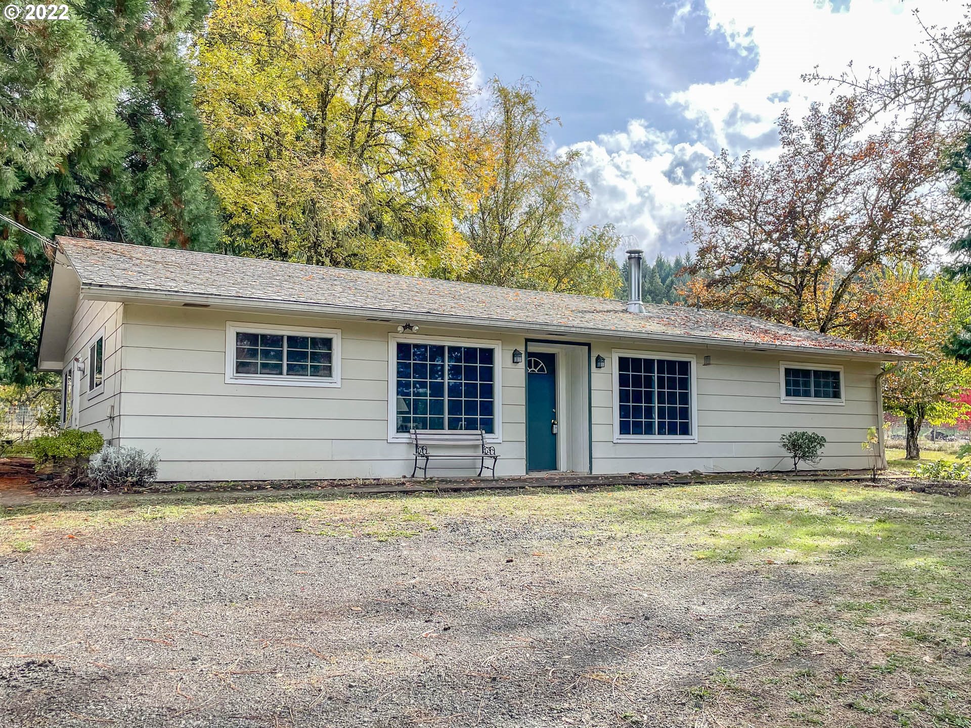 695 Lone Rock Road Glide, OR 97443 - Photo 2 of 48 a house with trees in the background