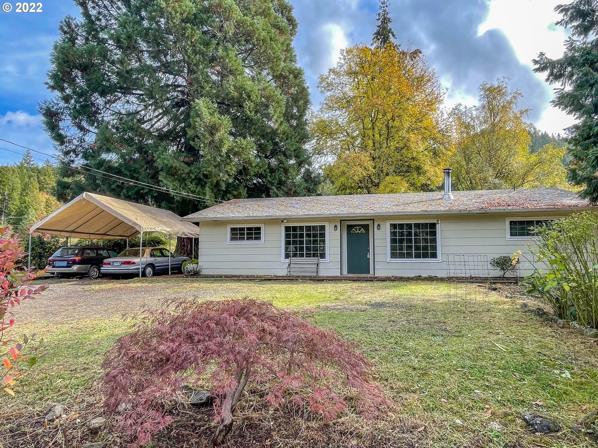 695 Lone Rock Road Glide, OR 97443 - Photo 21 of 48 a front view of house with yard and trees in the background
