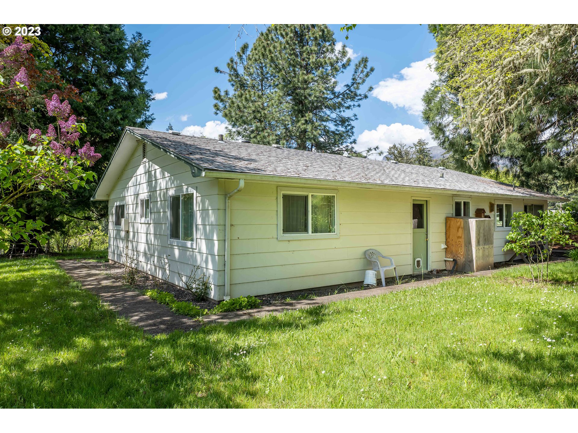 695 Lone Rock Road Glide, OR 97443 - Photo 24 of 48 a view of a house with a yard and sitting area