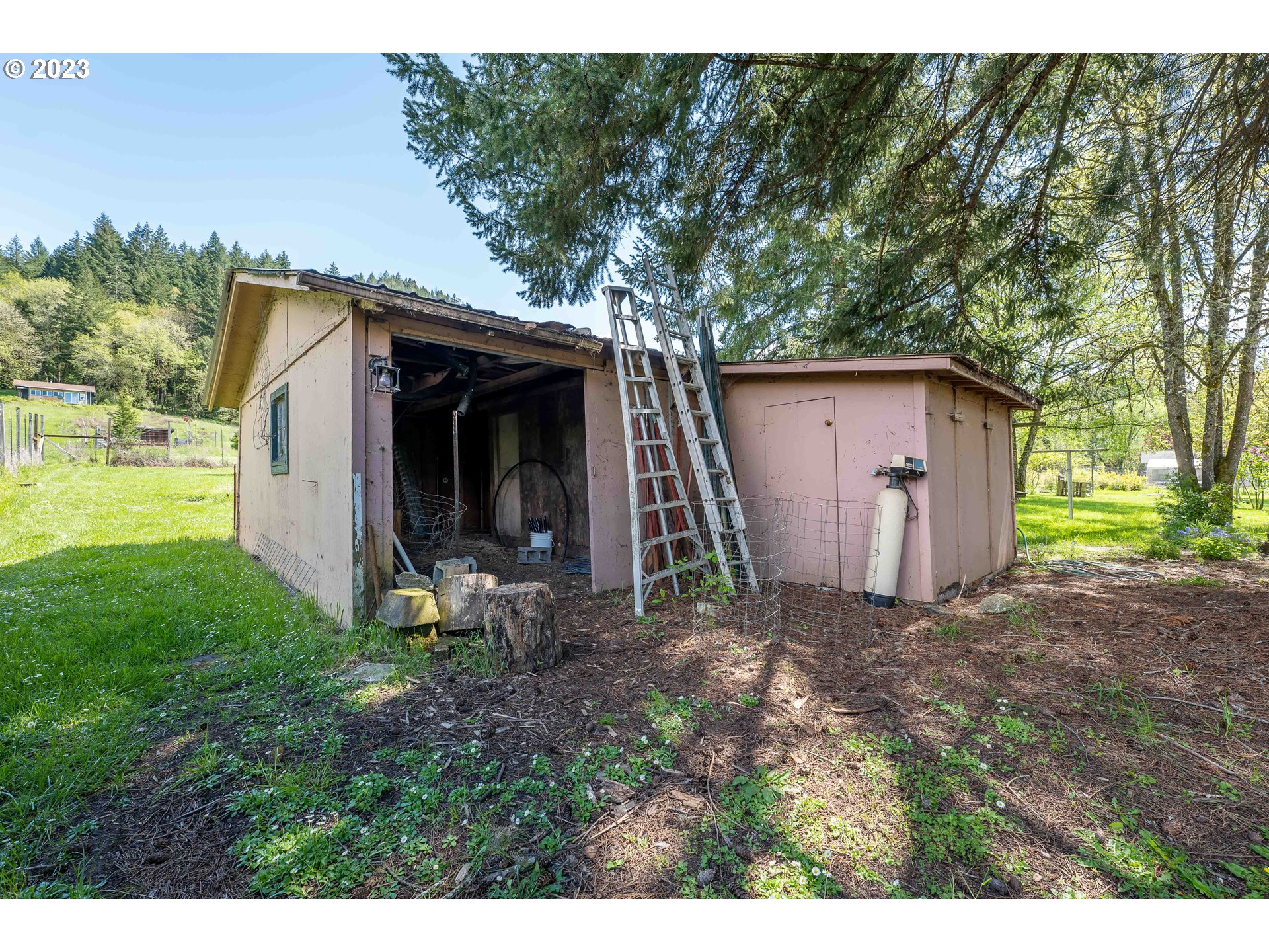 695 Lone Rock Road Glide, OR 97443 - Photo 34 of 48 a view of a barn in the middle of a yard