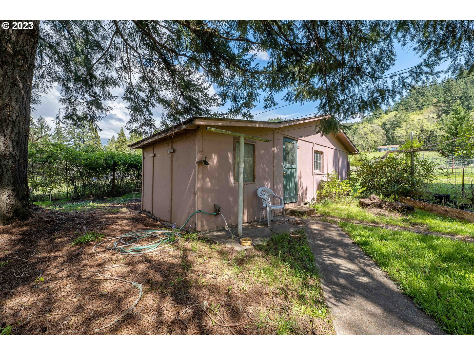 695 Lone Rock Road Glide, OR 97443 - Photo 36 of 48 a view of a barn house in the middle of forest