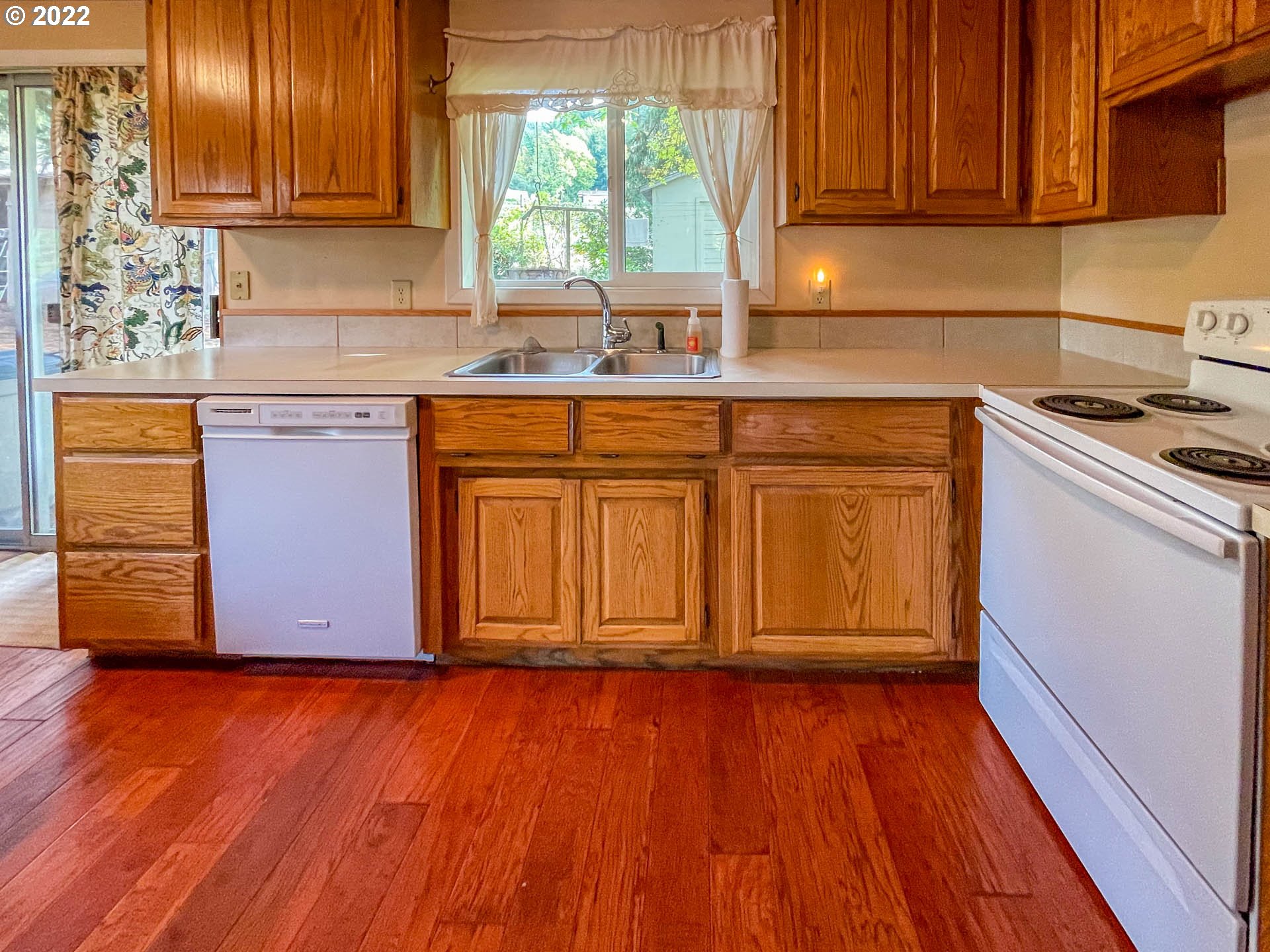695 Lone Rock Road Glide, OR 97443 - Photo 7 of 48 a kitchen with wooden floors and a sink