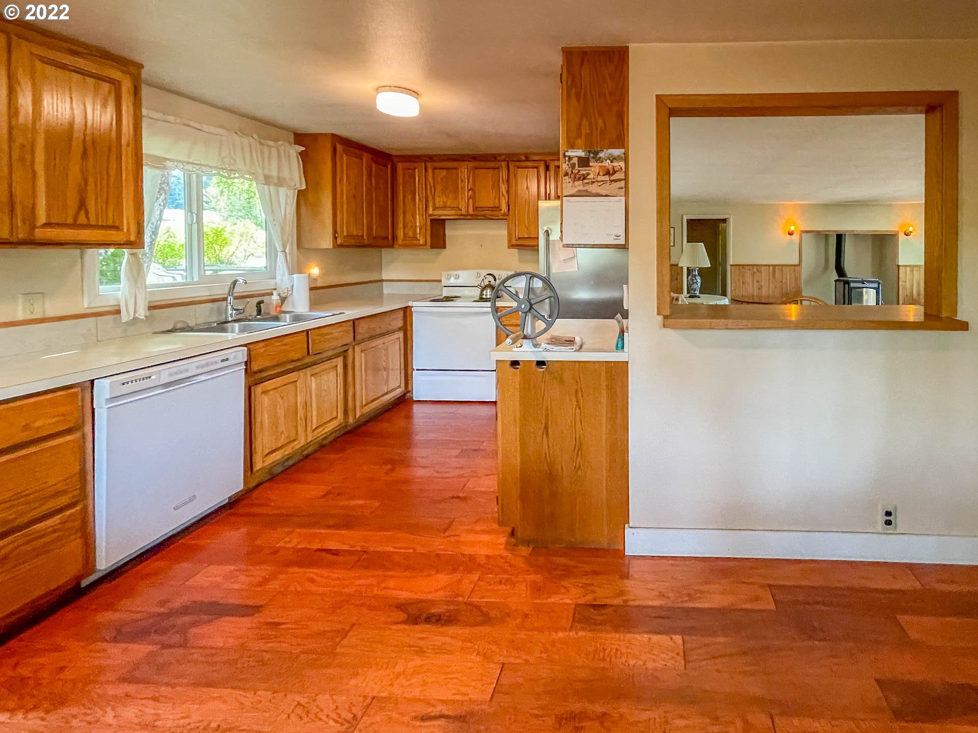 695 Lone Rock Road Glide, OR 97443 - Photo 9 of 48 a kitchen with stainless steel appliances granite countertop a sink wooden cabinets and a granite counter top