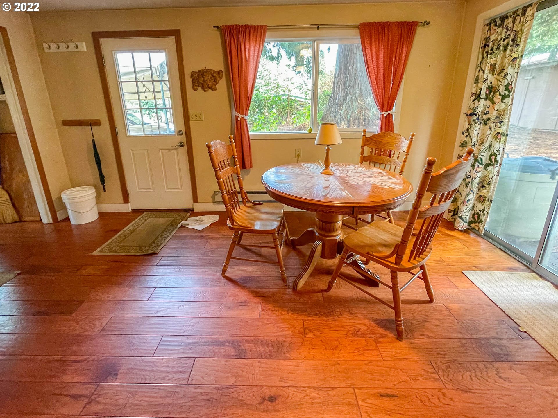 695 Lone Rock Road Glide, OR 97443 - Photo 10 of 48 a view of a dining room with furniture and wooden floor