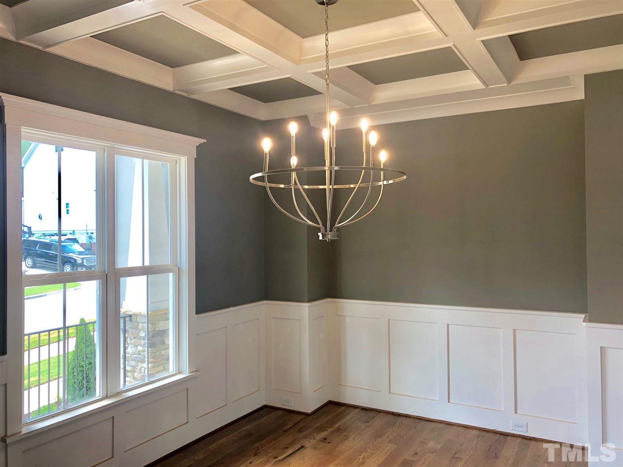 112 Roseroot Court Holly Springs, NC 27540 - Photo 2 of 30 a view of an empty room with wooden floor and windows