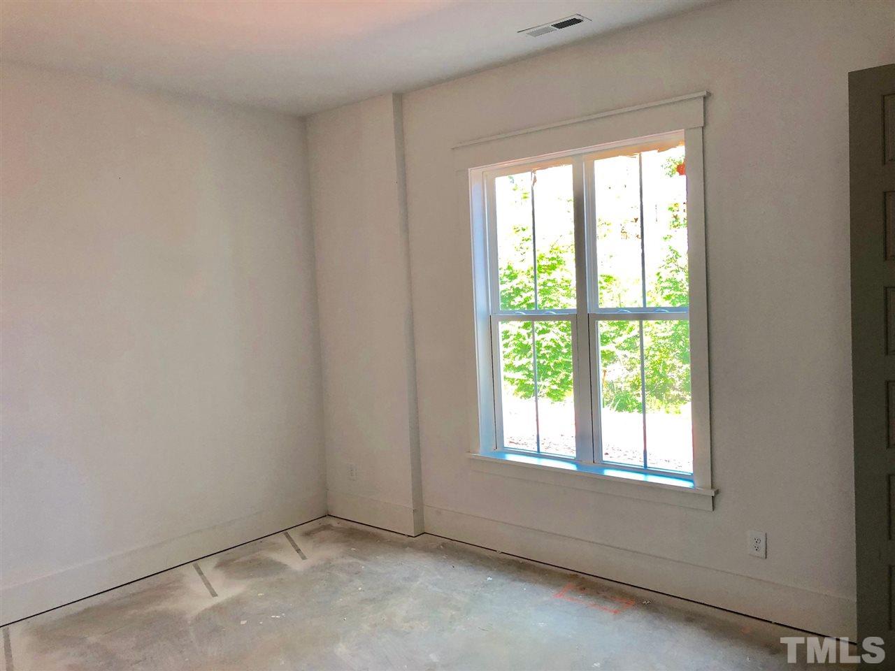112 Roseroot Court Holly Springs, NC 27540 - Photo 11 of 30 an empty room with a window