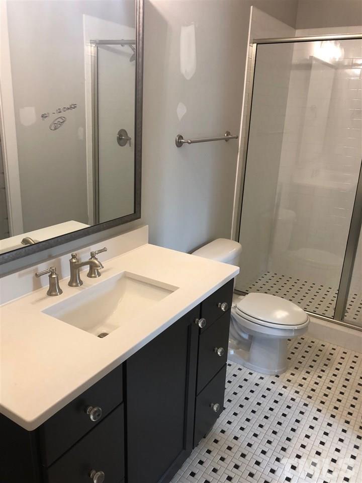 112 Roseroot Court Holly Springs, NC 27540 - Photo 12 of 30 a bathroom with a sink a toilet a shower and a mirror