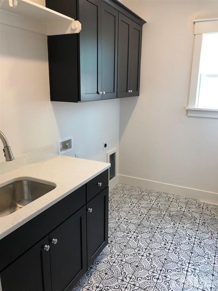 112 Roseroot Court Holly Springs, NC 27540 - Photo 13 of 30 a kitchen with a sink and cabinets